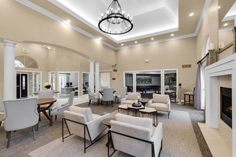 a large living room with couches and chairs and a fireplace